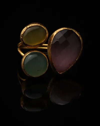 Plum & Seaglass - a gold-plated ring with three plum and sage green cat eye stones, on black